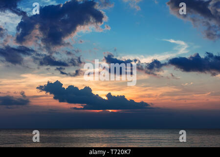 colorful cloudy sunset over ocean Stock Photo