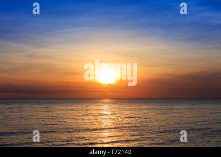 sunset over ocean on a clear day Stock Photo