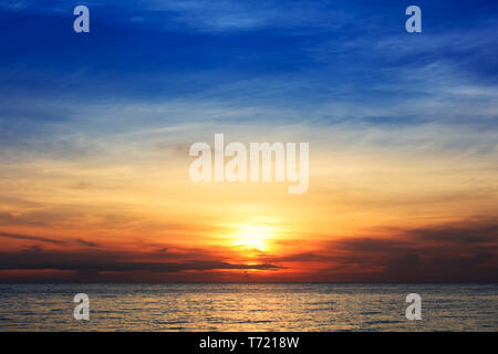 sunset over the ocean on clear day Stock Photo