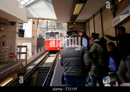 A Vieux Lyon-Fourvière Funiculaire rail car going downhill with people waiting on the platform to ride up, Lyon, France Stock Photo