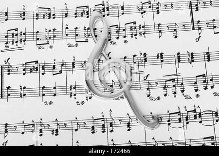 Treble clef on music sheet - musical background Stock Photo