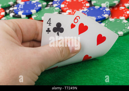 Hand with playing cards in casino Stock Photo