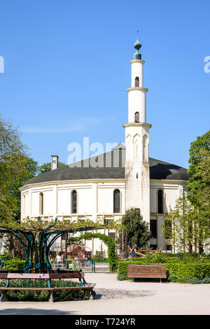 The Great Mosque of Brussels, Belgium, with a children playground in the Cinquantenaire Park in springtime. Stock Photo