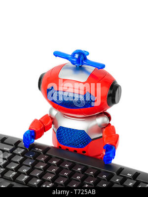 Toy robot and computer Stock Photo