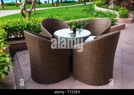 table and chairs in empty cafe next to pool Stock Photo