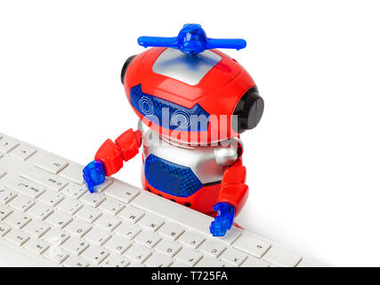 Toy robot and computer Stock Photo