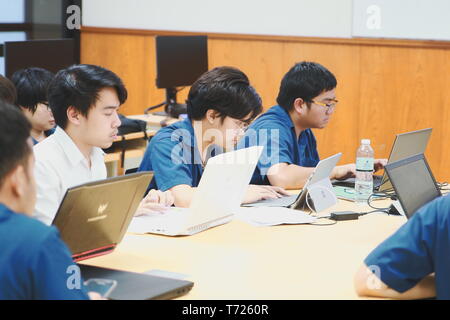 Groups of Computer Engineering students at Assumption University (ABAC) Working on their coding project in a classroom Stock Photo