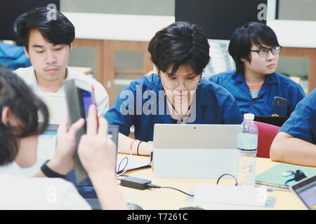 Groups of Computer Engineering students at Assumption University (ABAC) Working on their coding project in a classroom Stock Photo