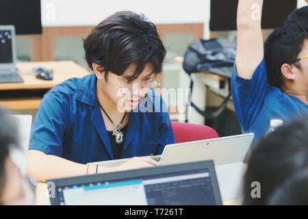 Portrait of a Computer Engineering student at Assumption University working on his coding project on his laptop Stock Photo