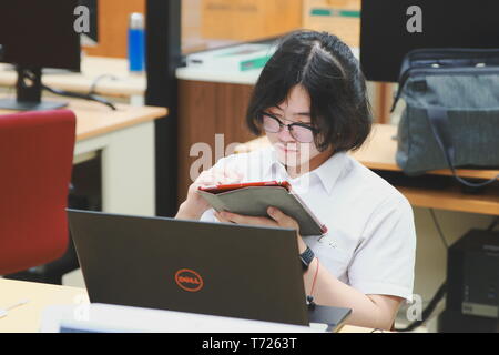 Chinese Computer Engineering Student taking lecture note on his iPad using Apple Pencil during a computer programming class Stock Photo