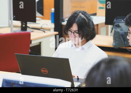 Chinese Computer Engineering Student taking lecture note on his iPad using Apple Pencil during a computer programming class Stock Photo