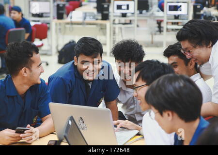Group of Asian computer engineering students working together to complete a computer programming project at an University Stock Photo