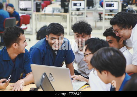 Group of Asian computer engineering students working together to complete a computer programming project at an University Stock Photo