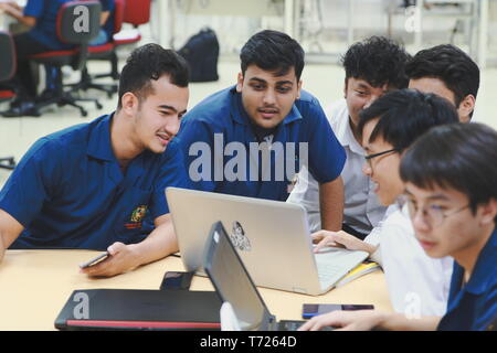 Group of Asian computer engineering students working together to complete a computer programming project at an University Stock Photo