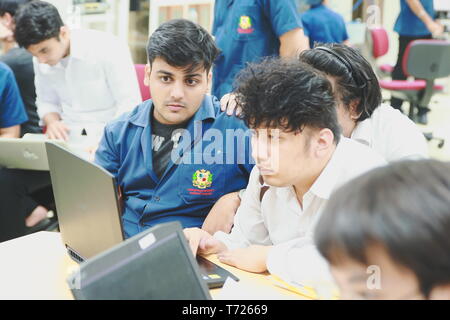 Group of multi ethnic computer engineering students working together to complete a computer programming project at an University Stock Photo