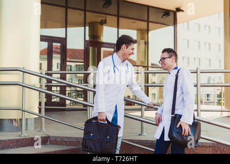 Education and health. general practitioner. A group of smart medical students in college. Friends interns on the background of the hospital. Teamwork  Stock Photo