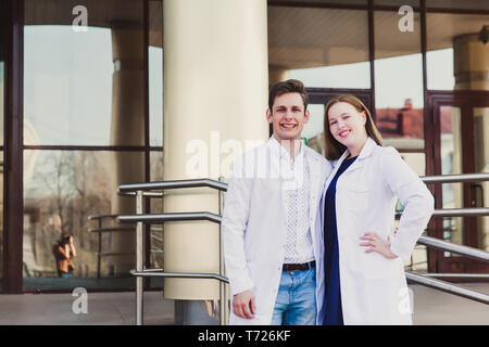 Education and health. general practitioner. A group of smart medical students in college. Friends interns on the background of the hospital. Teamwork  Stock Photo