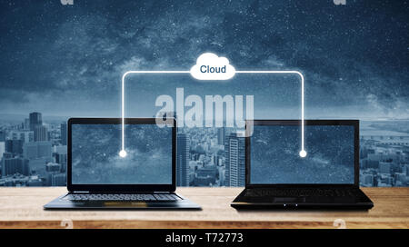 Computer laptops sharing data through cloud storage computing. Cloud computing and computer network concepts Stock Photo