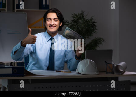 Young male architect working night at office Stock Photo