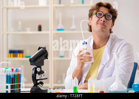 Funny crazy chemist doing experiments and tests Stock Photo
