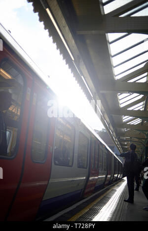 London Underground station in Earl's Court with trains and escalators Stock Photo