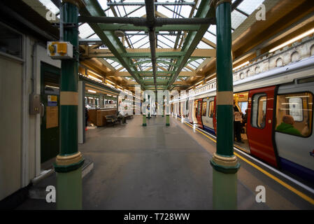 London Underground station in Earl's Court with trains and escalators Stock Photo