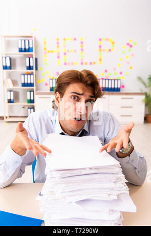 Young employee suffering from excessive work Stock Photo