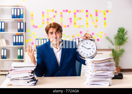 Young employee suffering from excessive work Stock Photo