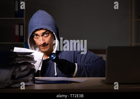 Thief trying to steal personal data in identity theft concept Stock Photo