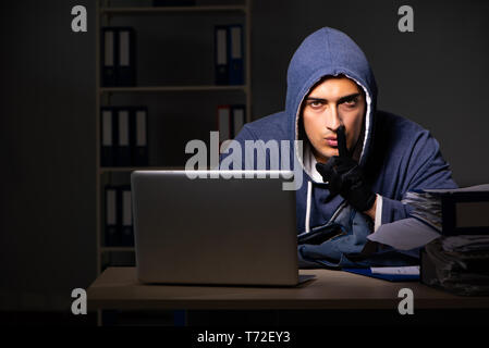 Thief trying to steal personal data in identity theft concept Stock Photo
