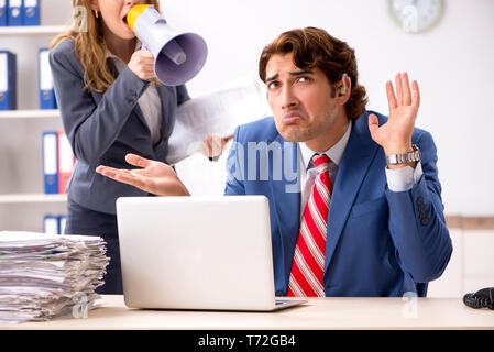 Deaf employee using hearing aid talking to boss Stock Photo