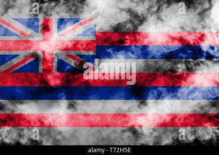 The national flag of the US state Hawaii in against a gray smoke on the day of independence in different colors of blue red and yellow. Political and  Stock Photo