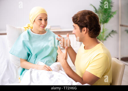 Husband looking after wife in hospital Stock Photo
