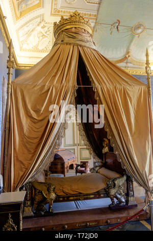 An ancient bed reminds of old times in the royal apartments of the 'Reggia di Caserta', a former palace and now a huge museum. Stock Photo