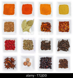 Different spices and herbs in a white bowl in top view Stock Photo