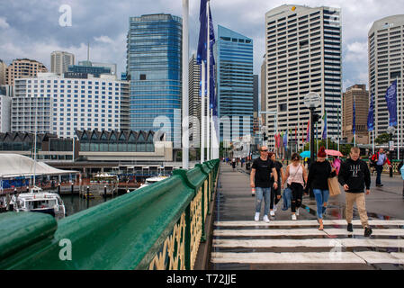 People walking across Pyrmont Bridge, Darling Harbour, Sydney, New South Wales, Australia Stock Photo