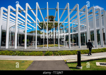 The Calyx building at the Royal Botanic Gardens with people relaxing in the gardens in Sydney, Australia Stock Photo