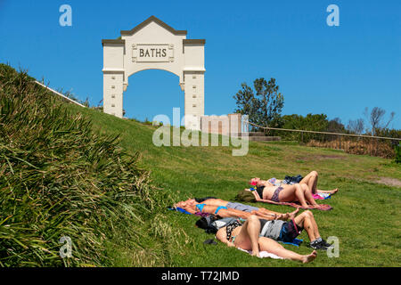 The Bondi beach to Coogee walk is a coastal walk in Sydney New South Wales, Australia. Sunbath in Coogee beach Dolphins Point and Giles Baths Stock Photo