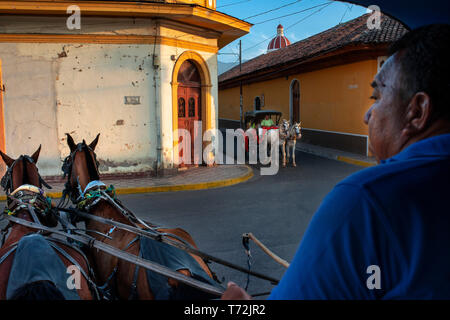 Horse drawn carriages next to Central Park the main plaza in the Spanish colonial city of Granada Nicaragua Central America Stock Photo