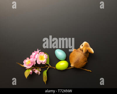a happy easter decoration with a bunny eggs and blossoms