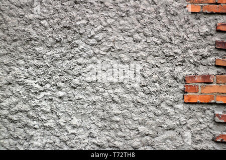 background of gray concrete wall with red bricks Stock Photo