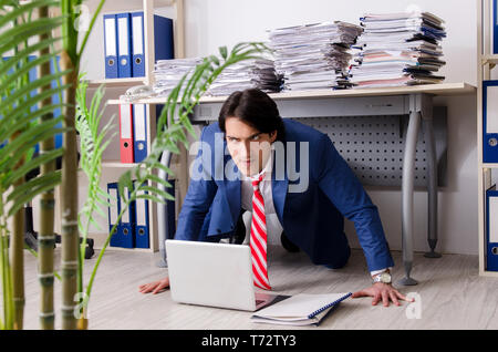 Young businessman employee unhappy with excessive work Stock Photo
