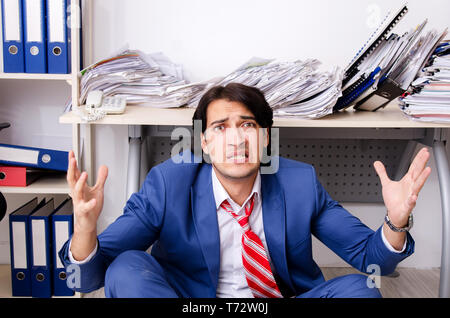 Young businessman employee unhappy with excessive work Stock Photo