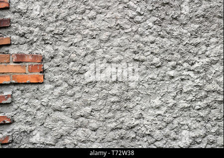 background of gray concrete wall with red bricks Stock Photo