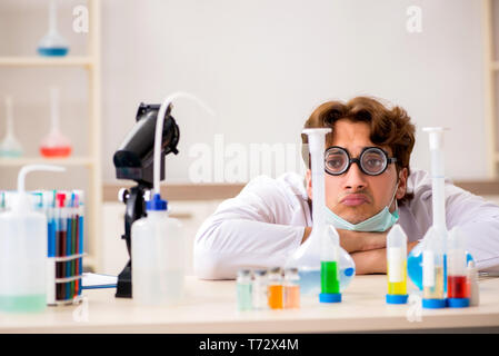 Funny crazy chemist doing experiments and tests Stock Photo