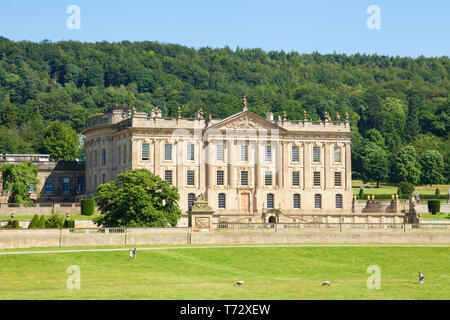 Chatsworth House park with people walking across the grass in parkland and woods Derbyshire England UK GB Europe Stock Photo