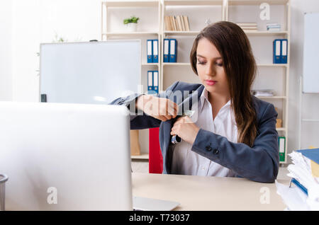 Beautiful female employee unhappy with excessive work Stock Photo