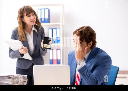 Deaf employee using hearing aid talking to boss Stock Photo