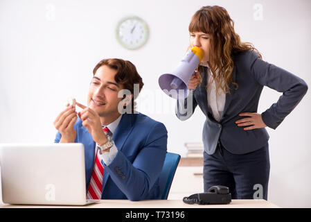 Deaf employee using hearing aid talking to boss Stock Photo