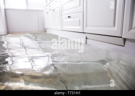 Close-up Of Flooded Floor In Kitchen From Water Leak Stock Photo